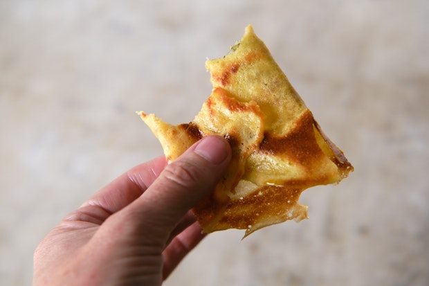 crepe with a bite out of it in a hand