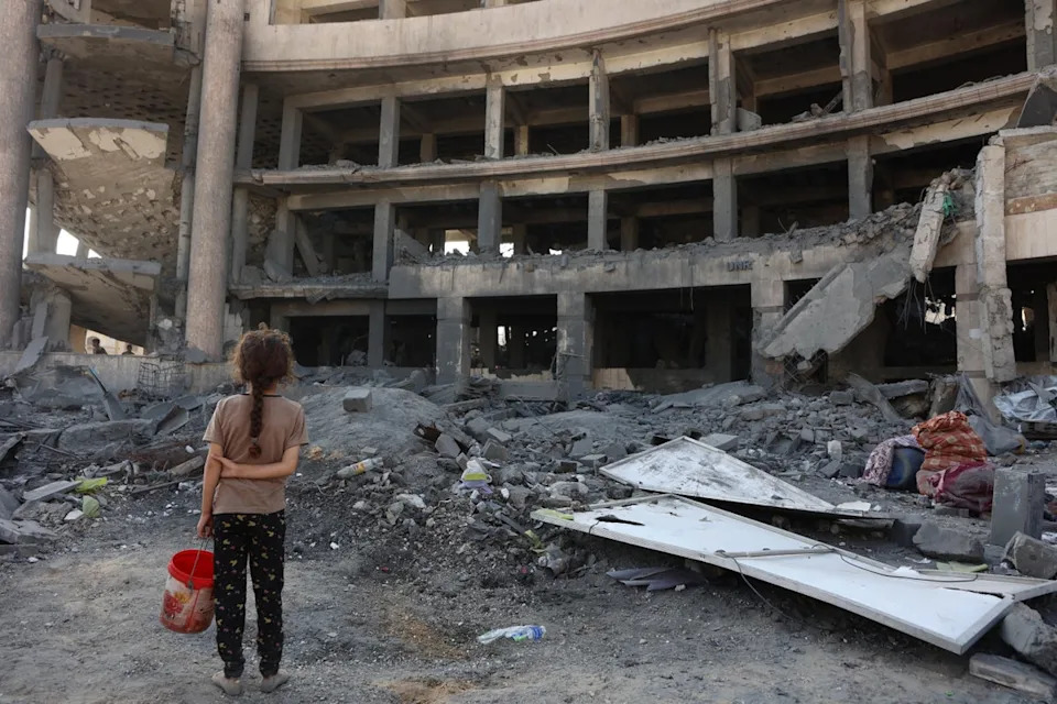 A Palestinian girl in the wreckage after an overnight strike on the Sheikh Radwan Health Centre in the north of Gaza City (AFP/Getty)