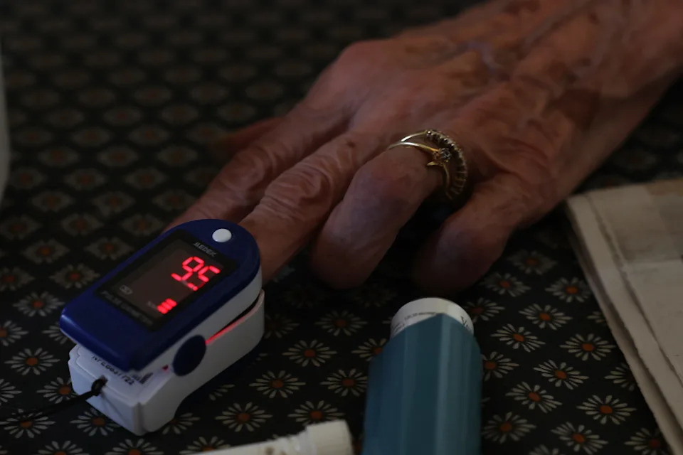 An elderly patient has her blood pressure taken by a nurse.