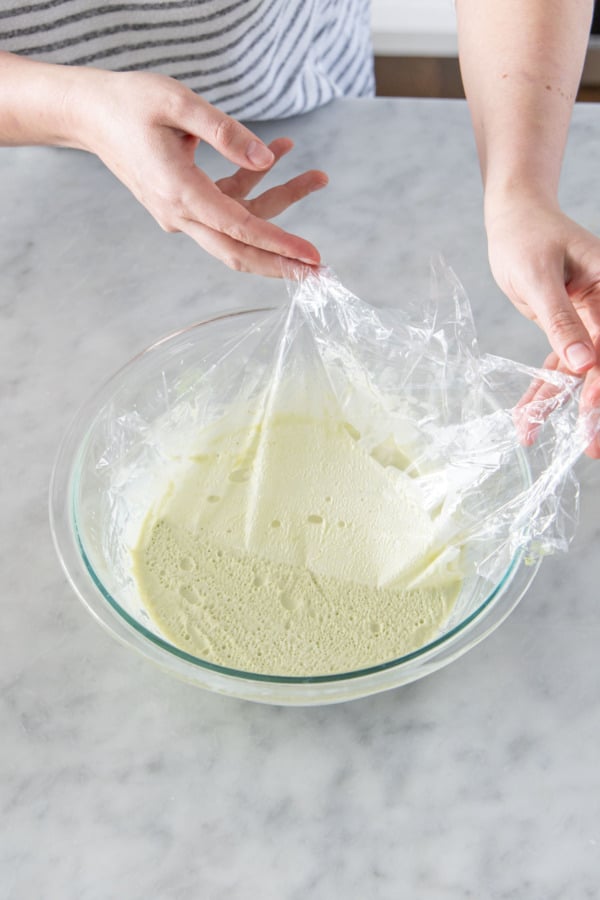 Peeling plastic wrap off the chilled ganache.