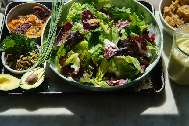 Ingredient for making citrus version of Caesar salad on a countertop