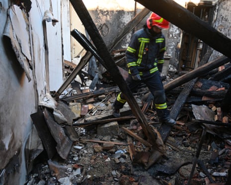 A rescue worker walks inside apartments destroyed by a Russian strike in Odesa, Ukraine.