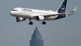A Lufthansa passenger plane lands at Frankfurt Airport The plane flies over the Messeturm. The airline presents its quarterly figures on Wednesday. 