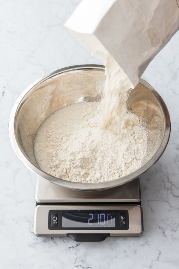 Adding bread flour to the poolish mixture.