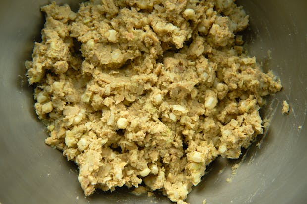 Ingredients for making tempeh ponzu balls after mixing in a stainless steel bowl