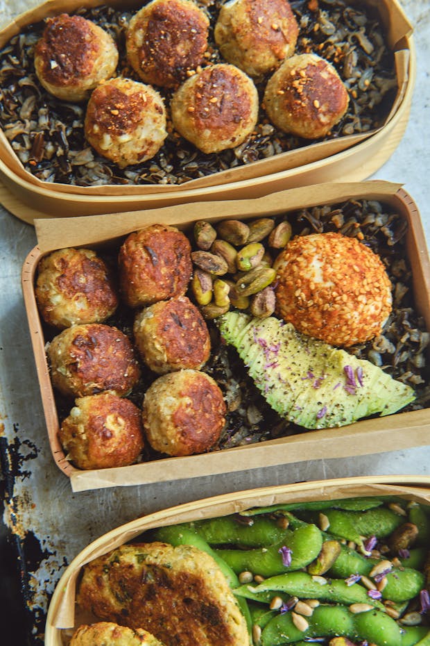 Pan-fried tempeh ponzu balls in a bento box with other lunch items